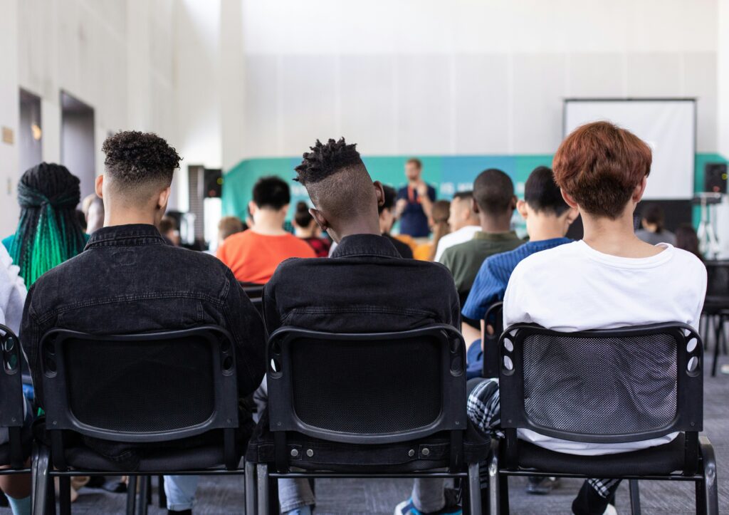 Why K12 Workshop Events Fail (And How Event Software Can Help) 2 Crowded Workshops With The Back Of Students Heads Losing Interest In The Speaker