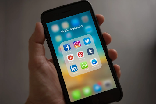 Book The Stars: How To Promote Your Call For Conference Speakers 2 Smatphone In Hand Showcasing Key Social Media Platforms To Enage Conference Speakers